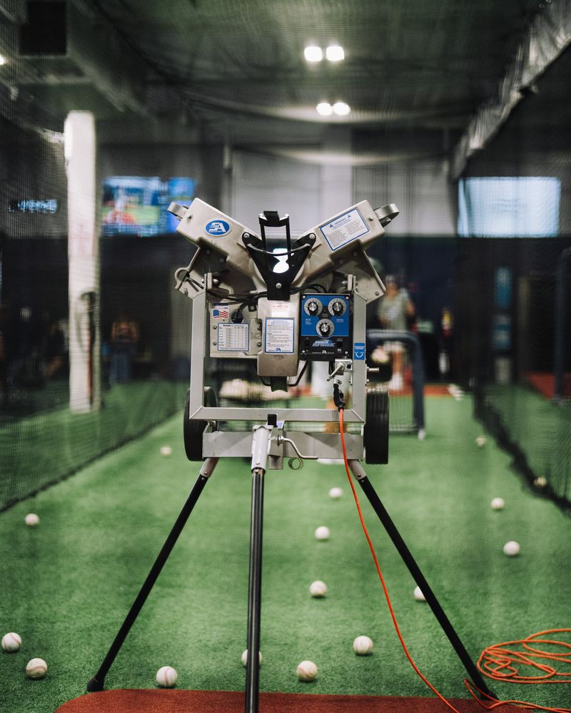 Pitching machine set up in a long cage