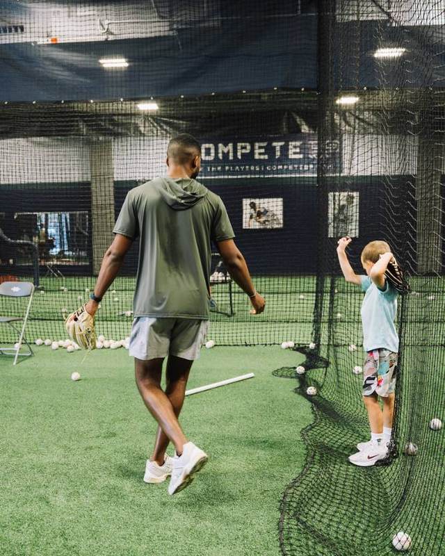 Coach and young outfielder working on throws